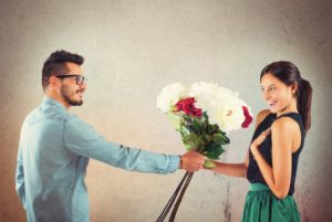 Lover boy gives flowers to his girlfriend